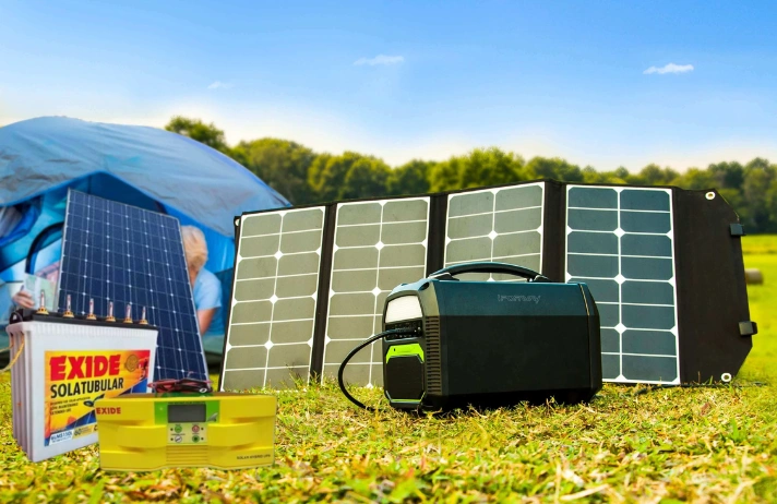 A portable solar generator next to a tent and a battery can power outdoor activities responsibly.